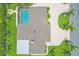 An aerial view of the house featuring a pool, driveway and pristine landscaping in a verdant setting at 7913 19Th Avenue W Dr, Bradenton, FL 34209