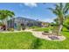 Well-manicured backyard with fire pit, screened pool area, and lush landscaping at 7913 19Th Avenue W Dr, Bradenton, FL 34209