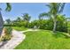 Spacious backyard with lush landscaping, paver walkway and fire pit seating area at 7913 19Th Avenue W Dr, Bradenton, FL 34209