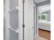 Bathroom featuring a linen closet, and view into bedroom with hardwood floors and a queen-size bed at 7913 19Th Avenue W Dr, Bradenton, FL 34209