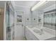 Bathroom featuring double sinks, a full mirror, and a view of the pool area at 7913 19Th Avenue W Dr, Bradenton, FL 34209