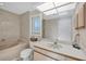 Bathroom featuring a marble-look tub, white cabinets and a large mirror at 7913 19Th Avenue W Dr, Bradenton, FL 34209