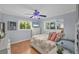 Comfortable bedroom with hardwood floors, ceiling fan, and natural light from two windows at 7913 19Th Avenue W Dr, Bradenton, FL 34209