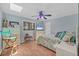 Comfortable bedroom with hardwood floors, ceiling fan, and natural light at 7913 19Th Avenue W Dr, Bradenton, FL 34209