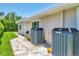 Side view of home featuring central air conditioning units and paver walkway at 7913 19Th Avenue W Dr, Bradenton, FL 34209