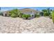 Exterior view of home with driveway, three-car garage, lush landscaping, and side yard at 7913 19Th Avenue W Dr, Bradenton, FL 34209
