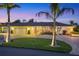 Stunning exterior shot of a home with lush landscaping, circular driveway, and a two-car garage at 7913 19Th Avenue W Dr, Bradenton, FL 34209