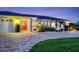 Charming front entrance featuring a double door, well-manicured landscaping, and a circular driveway at 7913 19Th Avenue W Dr, Bradenton, FL 34209