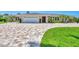 Charming home with brick driveway, manicured lawn, and lush tropical landscaping at 7913 19Th Avenue W Dr, Bradenton, FL 34209