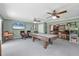 Spacious game room with a pool table, wet bar, and a large television at 7913 19Th Avenue W Dr, Bradenton, FL 34209