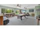 Large game room with a pool table, wet bar, and a comfortable seating area at 7913 19Th Avenue W Dr, Bradenton, FL 34209