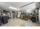 Spacious garage with ample storage, a stainless steel refrigerator, and a well-organized workbench at 7913 19Th Avenue W Dr, Bradenton, FL 34209