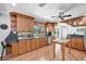 Charming kitchen featuring wood cabinets, granite counters, and a center island with a breakfast bar at 7913 19Th Avenue W Dr, Bradenton, FL 34209