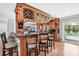 Gourmet kitchen features an island with bar seating, opening to the living space and offering views of the inviting pool at 7913 19Th Avenue W Dr, Bradenton, FL 34209