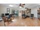 Open living room featuring wood floors, a stone accent wall, and an adjoining office at 7913 19Th Avenue W Dr, Bradenton, FL 34209