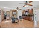 Comfortable living area featuring hardwood floors, a stone accent wall, and built-in bar area with wood cabinets at 7913 19Th Avenue W Dr, Bradenton, FL 34209