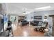 Open-concept living room with skylight and hardwood floors, with view of kitchen, pool, and lanai at 7913 19Th Avenue W Dr, Bradenton, FL 34209