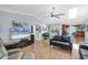 Open-concept living room with skylight and hardwood floors, with view of kitchen, pool, and lanai at 7913 19Th Avenue W Dr, Bradenton, FL 34209