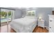 Bright main bedroom with hardwood floors, a walkout to the pool, and a comfortable king-size bed at 7913 19Th Avenue W Dr, Bradenton, FL 34209