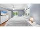 Bright bedroom with hardwood floors, white furnishings, ceiling fan and a walkout to the pool area at 7913 19Th Avenue W Dr, Bradenton, FL 34209
