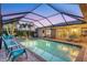 Covered pool with an outdoor seating area, surrounded by tropical plants at 7913 19Th Avenue W Dr, Bradenton, FL 34209