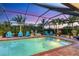 Inviting screened-in pool area with comfortable seating, surrounded by palm trees and lush greenery for ultimate relaxation at 7913 19Th Avenue W Dr, Bradenton, FL 34209