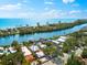 Waterfront property featuring lush greenery, a swimming pool, and Gulf access at 8234 Midnight Pass Rd, Sarasota, FL 34242