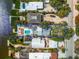 Aerial view of a waterfront home with lush trees, a private pool and access to the river at 8234 Midnight Pass Rd, Sarasota, FL 34242