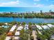 Waterfront home with lush landscaping, a pool, and canal access to ocean, offering luxury coastal living at 8234 Midnight Pass Rd, Sarasota, FL 34242