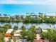 Waterfront home with mature trees, convenient street access, and stunning ocean views in the distance at 8234 Midnight Pass Rd, Sarasota, FL 34242
