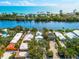 Stunning aerial view of waterfront homes along a tranquil river leading to the ocean at 8234 Midnight Pass Rd, Sarasota, FL 34242