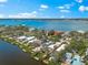 Waterfront home features lush greenery, a private pool, and canal access to the ocean, offering scenic views at 8234 Midnight Pass Rd, Sarasota, FL 34242