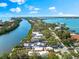 Aerial view of waterfront property with pool in desirable location, lush landscaping, and private dock at 8234 Midnight Pass Rd, Sarasota, FL 34242