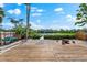 Waterfront backyard with wooden deck, fire pit, and easy access to the waterway for kayaks or canoes at 8234 Midnight Pass Rd, Sarasota, FL 34242