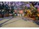 Backyard with gravel, string lights, a screened-in porch and mature trees, creating a cozy outdoor space at 8234 Midnight Pass Rd, Sarasota, FL 34242