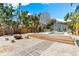 Backyard with a fire pit, deck, pool, landscaping and pavers at 8234 Midnight Pass Rd, Sarasota, FL 34242