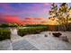 Backyard with a fire pit, a path to the dock, and a beautiful sunset in the background at 8234 Midnight Pass Rd, Sarasota, FL 34242
