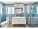 Modern bathroom with dual sink vanity, toilet, and walk-in shower featuring pebble floor and striking blue marble-look tile at 8234 Midnight Pass Rd, Sarasota, FL 34242