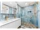 Sleek bathroom with dual sink vanity, and walk-in shower featuring pebble floor and striking blue marble-look tile at 8234 Midnight Pass Rd, Sarasota, FL 34242