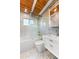 Bright bathroom featuring modern tub-shower combo, white vanity, and eye-catching hexagon tile floor and accent wall at 8234 Midnight Pass Rd, Sarasota, FL 34242