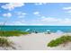 Sunny day at the beach with people relaxing by the ocean at 8234 Midnight Pass Rd, Sarasota, FL 34242