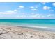A stunning view of a calm ocean and sandy beach at 8234 Midnight Pass Rd, Sarasota, FL 34242