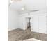 Spacious bedroom with wood-look flooring, ceiling fan, closet, and bright white paint at 8234 Midnight Pass Rd, Sarasota, FL 34242