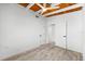Bedroom with wood ceiling, and open door with views to other parts of the home at 8234 Midnight Pass Rd, Sarasota, FL 34242