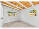 A bright bedroom with a wood ceiling, modern fan, light flooring and two large windows at 8234 Midnight Pass Rd, Sarasota, FL 34242