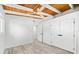 Bedroom with wood ceiling, modern fan, wood-look flooring, and closet space at 8234 Midnight Pass Rd, Sarasota, FL 34242