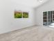 A bright bedroom with wood-look floors, white walls and natural light coming through the windows at 8234 Midnight Pass Rd, Sarasota, FL 34242