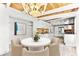 Dining room view of modern kitchen featuring wood ceilings, white walls, and view of chandelier at 8234 Midnight Pass Rd, Sarasota, FL 34242