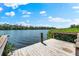 Charming waterfront dock with wood railing overlooking scenic views of calm waters and lush green vegetation at 8234 Midnight Pass Rd, Sarasota, FL 34242