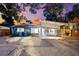 Attractive home exterior featuring a screened-in porch, meticulous landscaping, and fresh paint at 8234 Midnight Pass Rd, Sarasota, FL 34242